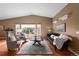 Bright living room with a vaulted ceiling, plush seating, and a large rug creating a cozy atmosphere at 4927 Greenwich Way, Highlands Ranch, CO 80130