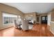 Open-concept living area with hardwood floors, plenty of natural light, and views to the entryway at 4927 Greenwich Way, Highlands Ranch, CO 80130