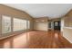 Open living room with wood floors, large windows, and a view of the front entrance at 4927 Greenwich Way, Highlands Ranch, CO 80130
