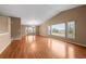 Spacious living room with hardwood floors, vaulted ceiling, and large bay windows at 4927 Greenwich Way, Highlands Ranch, CO 80130