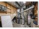 Furnace and hot water heater with a humidifier and electrical panel in the basement at 4927 Greenwich Way, Highlands Ranch, CO 80130