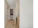 Hallway with light walls and light wood floors at 2773 S Harrison St, Denver, CO 80210