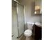 Bathroom featuring a shower with a glass door, a standard toilet, and an elegant vanity sink at 772 Victor St, Aurora, CO 80011