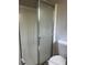 Bathroom featuring a shower with a glass door and brushed metal hardware and a standard white toilet at 772 Victor St, Aurora, CO 80011