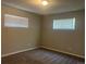 Bright bedroom featuring neutral paint, carpet flooring, and two windows with blinds for natural light at 772 Victor St, Aurora, CO 80011