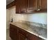 Kitchen with updated countertops and brown cabinetry at 772 Victor St, Aurora, CO 80011