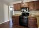 Kitchen featuring wood cabinets, granite countertops, and stainless steel appliances at 772 Victor St, Aurora, CO 80011