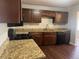 Kitchen featuring wood cabinets, granite countertops, and stainless steel appliances at 772 Victor St, Aurora, CO 80011