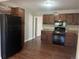 Kitchen featuring stainless steel appliances, wood cabinets, and granite countertops at 772 Victor St, Aurora, CO 80011