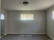 Spacious living room with gray carpet and neutral walls and window bringing in the natural light at 772 Victor St, Aurora, CO 80011
