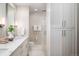 Modern bathroom with marble countertop, walk-in shower, and ample storage at 1631 N Emerson St # 117, Denver, CO 80218