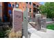 Charming brick building entrance with clear address signage and secure gate access at 1631 N Emerson St # 117, Denver, CO 80218