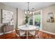 Bright dining room with modern chandelier and access to the outdoor patio at 1631 N Emerson St # 117, Denver, CO 80218