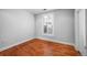 Hardwood-floored room with natural light through shuttered window at 1631 N Emerson St # 117, Denver, CO 80218