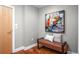 Inviting entryway featuring stylish bench seating and a colorful art piece on the wall at 1631 N Emerson St # 117, Denver, CO 80218