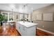 Open kitchen layout with white cabinetry, stainless steel appliances and view to the patio at 1631 N Emerson St # 117, Denver, CO 80218