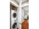 Efficient laundry closet featuring a stacked washer and dryer, conveniently located near the bedroom at 1631 N Emerson St # 117, Denver, CO 80218