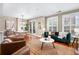 Bright living room with ample natural lighting, hardwood floors, and open floor plan at 1631 N Emerson St # 117, Denver, CO 80218