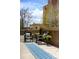Private patio seating area with wicker furniture, offering a cozy outdoor space at 1631 N Emerson St # 117, Denver, CO 80218