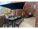 Outdoor dining set on the patio with a large umbrella providing shade at 1631 N Emerson St # 117, Denver, CO 80218