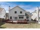 A spacious backyard with a deck, lawn, and privacy fence at 9866 Spring Hill Ln, Highlands Ranch, CO 80129