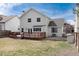 The backyard has a deck with steps down to the lawn and fence at 9866 Spring Hill Ln, Highlands Ranch, CO 80129