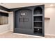 Close-up of basement entertainment center boasting modern dark blue shelving and mounted TV area at 9866 Spring Hill Ln, Highlands Ranch, CO 80129