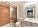 Bathroom featuring glass-enclosed shower with brown tiling, white sink, and light fixture above mirror at 9866 Spring Hill Ln, Highlands Ranch, CO 80129