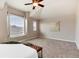 Bedroom featuring a large window, plush carpeting, neutral colored walls, and elegant decor at 9866 Spring Hill Ln, Highlands Ranch, CO 80129