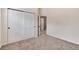 Bedroom with carpet, closet with sliding doors, and open doorway to a hallway at 9866 Spring Hill Ln, Highlands Ranch, CO 80129