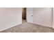 Neutral-toned bedroom with plush carpeting and a bright, airy feel from natural light streaming through open doorway at 9866 Spring Hill Ln, Highlands Ranch, CO 80129
