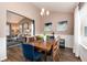 Elegant dining room connected to the living room, featuring a wooden table and ample natural light at 9866 Spring Hill Ln, Highlands Ranch, CO 80129