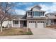 Charming two-story home with brick and siding exterior and attached two-car garage in a residential neighborhood at 9866 Spring Hill Ln, Highlands Ranch, CO 80129