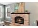Close up of the brick fireplace in the living room with decorative mantle and burning fire at 9866 Spring Hill Ln, Highlands Ranch, CO 80129