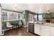 Bright kitchen with connected breakfast nook and a view to the living room featuring a fireplace at 9866 Spring Hill Ln, Highlands Ranch, CO 80129