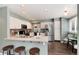 Open concept kitchen with breakfast bar, stainless appliances, and dining area with table at 9866 Spring Hill Ln, Highlands Ranch, CO 80129