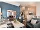 Spacious living area with open access to the dining room, creating a seamless flow for entertaining at 9866 Spring Hill Ln, Highlands Ranch, CO 80129