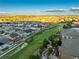 Expansive aerial shot of a residential area showcasing well-maintained homes, landscaping, and community layout against mountain backdrop at 3790 Mighty Oaks St, Castle Rock, CO 80104