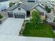 Aerial view of a two-story home, three-car garage and large driveway in a desirable suburban neighborhood at 3790 Mighty Oaks St, Castle Rock, CO 80104