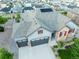 Aerial view of a two-story home with solar panels and a three-car garage in a suburban neighborhood at 3790 Mighty Oaks St, Castle Rock, CO 80104