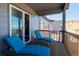 Relaxing back porch features two blue lounge chairs, wood decking and views of the surrounding neighborhood at 3790 Mighty Oaks St, Castle Rock, CO 80104