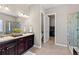 Luxurious bathroom features dual sinks, granite countertops, and a walk-in shower at 3790 Mighty Oaks St, Castle Rock, CO 80104