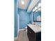 Stylish blue bathroom with updated vanity, modern lighting, and sleek fixtures at 3790 Mighty Oaks St, Castle Rock, CO 80104