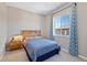 Cozy bedroom featuring a comfortable bed with stylish bedding, a nightstand, and a large window for natural light at 3790 Mighty Oaks St, Castle Rock, CO 80104