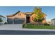 Two-story home has a three-car garage, stone accents, red shutters, and a well-manicured lawn at 3790 Mighty Oaks St, Castle Rock, CO 80104