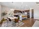 Modern kitchen with stainless steel appliances, granite countertops, a breakfast bar and an adjacent dining area at 3790 Mighty Oaks St, Castle Rock, CO 80104
