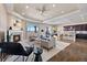 Spacious open-concept living room with fireplace, dining area, and modern kitchen with breakfast bar at 3790 Mighty Oaks St, Castle Rock, CO 80104