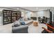 Basement living area with bookshelves, comfortable seating, and a game table at 3040 S Dexter Way, Denver, CO 80222