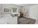 Bright bedroom with a large window, built-in shelves, and wood floors at 3040 S Dexter Way, Denver, CO 80222