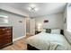 Cozy bedroom with hardwood floors, dresser, and neutral decor at 3040 S Dexter Way, Denver, CO 80222